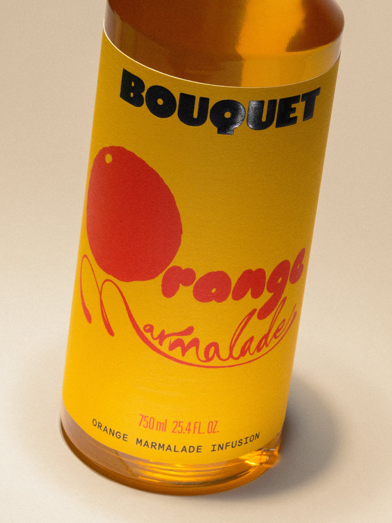 Close-up of a backlit orange slice on a warm yellow background