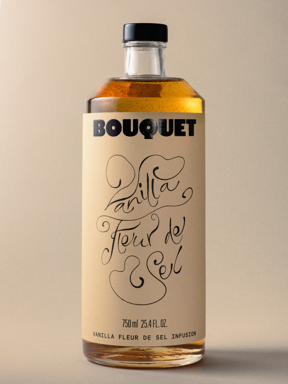 Bottle of Bouquet Vanilla Fleur de Sel infusion with a cream colored label, bold black BOUQUET logo, and large black graphic. Text reads ‘Vanilla Fleur de Sel’ in black. 750 ml (25.4 fl oz).