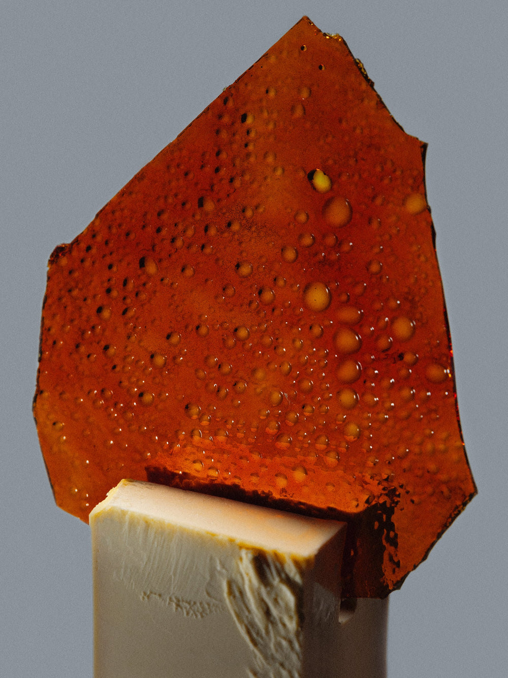 Caramelized orange shard sitting on a block of butter,  representing one of Bouquet’s infusions flavor profile